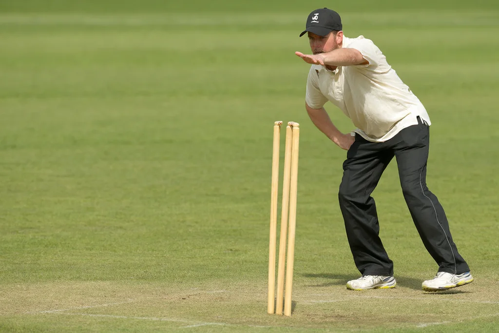 A bowler practising at a set of stumps on a training pitch