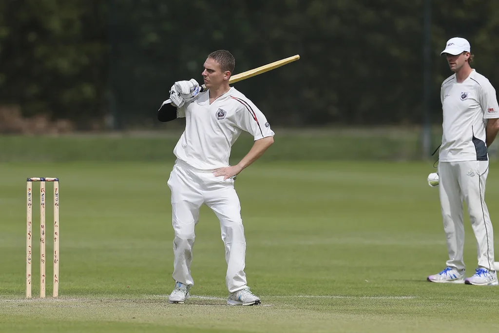 A cricket training session with a bowler practising at the stumps